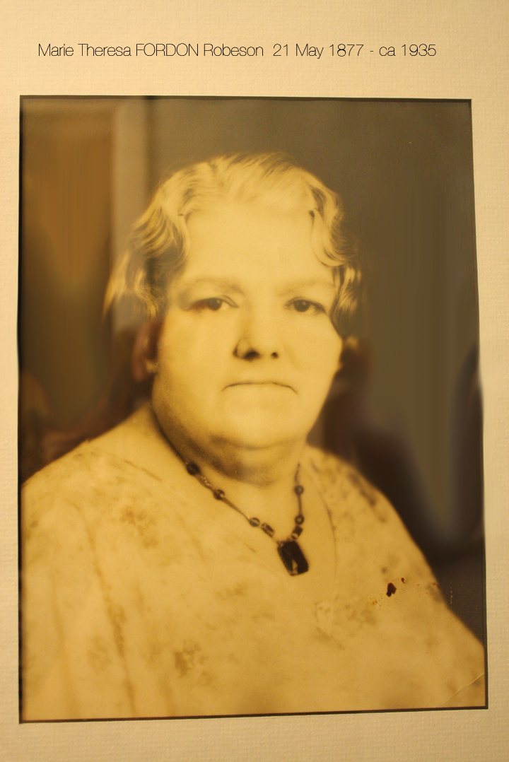 Hand-tinted portrait of Marie Theresa Fordon Robeson, an older woman with waved white hair and a beaded necklace